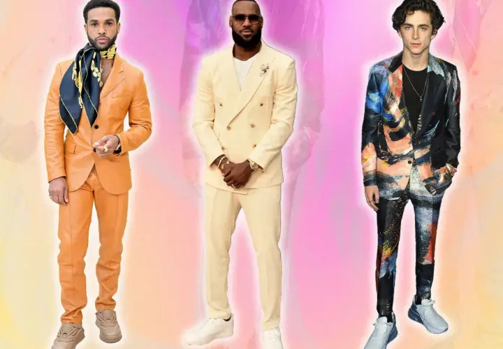 Trois hommes posent. L'un porte un costume beige et des baskets blanches.
