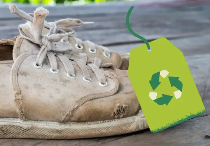 Vieilles baskets usées avec un symbole de recyclage vert. Une question se pose : où jeter des chaussures ?