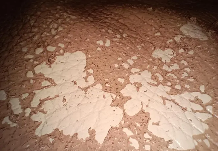 Texture de cuir décoloré par l'acétone, révélant des motifs abstraits et des zones claires.